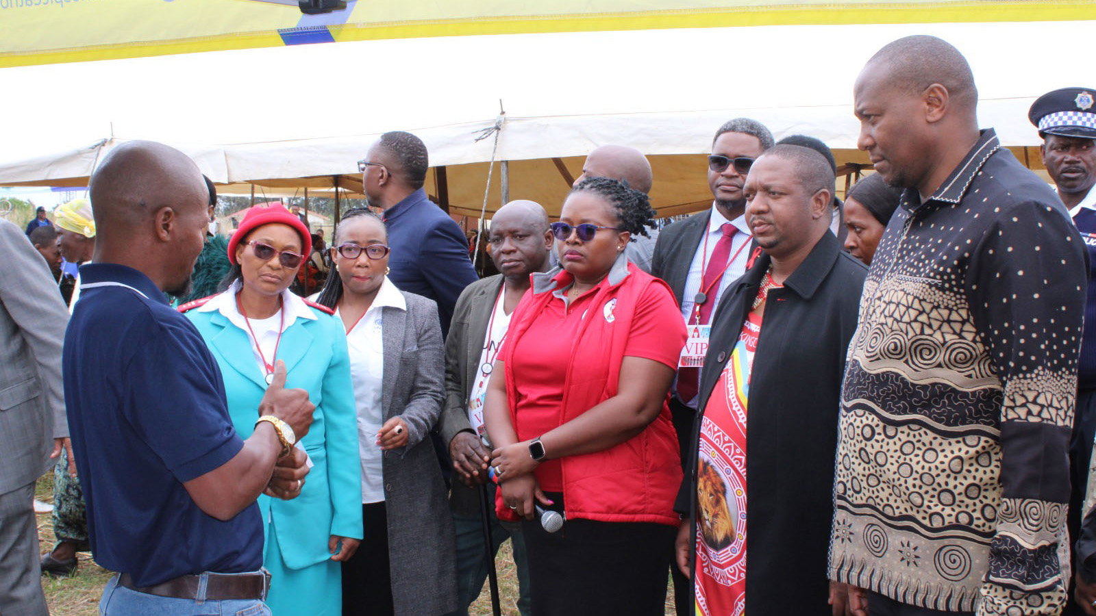 The Prime Minister, Russell Mmiso Dlamini, and other officials listening to a Hospice at Home representative, when they visited their stall at the commemoration. 